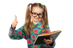 Girl with glasses reading a book on white background